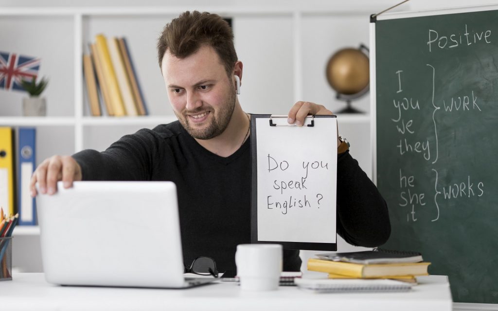 teacher-doing-an-english-lesson-online-for-his-students